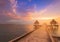 Natural sunset sky over seacoast skyline with walking path