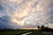 Natural Sunset Sunrise Over Field Or Meadow. Bright Dramatic Sky And Dark Ground. Countryside Landscape Under Scenic