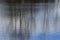 Natural texture of the reflection of branches and sky in the water of the reservoir