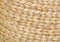 Natural textured background of light coloured woven grass type material