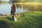 Natural tourist woman, she is doing breakfast, eating food. Travel camping, Travel camping by lake. Campers are on their camp at
