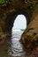 Natural tunnel in the rock dug by sea waves