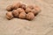 Natural, unbroken nuts on a jute bag background. Selective focus