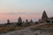 Natural valley with volcanic tuff stone rocks in Goreme in Cappadocia, Turkey, at sunset.