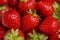 Natural vegetable red background from ripe strawberries