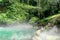 Natural Volcanic Blue Hot Spring Water with Blur Boulder in Front
