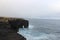 Natural volcanic sea arch on a rocky coastline