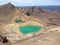 Natural vulcanic green lake in a crater, hiking the Taupo Tongariro Alpine Crossing with moon landscape