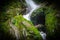 A natural waterfall in hills of sikkim, india in between forest vegetation with captured with slow shutter speed
