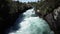 Natural waterfall Huka falls river water with high pressure next to the rocks, New Zealand