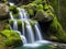 Natural waterfall surrounded by rocks and moss.