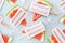Natural watermelon juice popsicles with ice cubes over gray tray