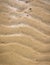 Natural wave pattern in sand on a beach texture.