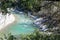 Natural and wild river in Provence, seen through pine branches .