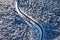 Natural winter landscape from air. Aerial view on the road and forest at the winter time. Winter chill. Forest and snow.