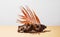 Natural wood driftwood with a complex texture on a beige background with a dry palm leaf and shadow