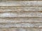 Natural wooden planks stacked horizontally making a board with rough texture and wood patterns for surface coverage