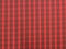 Natural wool fabric. Tartan plaid fabric pattern background textured. Close-up red fabric texture.