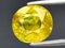 natural yellow grossular garnet gem on the background