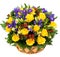 Natural yellow roses and blue irises in a basket