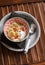 Natural yoghurt with banana, dried apricots and crunchy granola in a vintage bowl