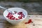 Natural yoghurt cream with fresh red currants in a white bowl, h