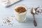 Natural yogurt with ground flax seeds in glasses on a light blue background