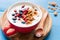 Natural yogurt with honey granola, pomegranate and blueberries