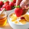 Natural yogurt with strawberries garnished with honey and cereals