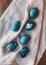 Naturally dyed cyan blue pressed flower Easter eggs.