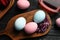 Naturally painted Easter eggs on black wooden table, flat lay. Red cabbage used for coloring