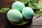 Naturally painted Easter eggs on wooden table, closeup. Spinach used for coloring