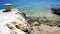 Nature background with detail of sea coastline and wild pebble beach and stone mooring bollard