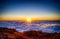 Nature background with sunrise over clouds. It is on the top of Pico do Arieiro mountain, Madeira island, Portugal. The rising sun