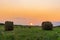 Nature background. Two bales of straw on foreground on the autumn meadow during wonderful sunset light