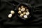 Nature conceptual photography with quail eggs on a black background
