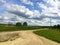 Nature. Cumulus clouds. Meadow. Dirt road