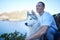 Nature, dog and man with husky in mountain for hiking, walking and fresh air together by lake. Traveling, friendship and