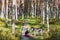 Nature Estonia on the Selisoo swamp. Little girl with a husky dog â€‹â€‹in the forest on an autumn day