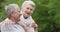 Nature, face and elderly happy couple hug, love and care for partner in outdoor date, wellness or sustainable garden