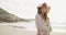 Nature, hat and happy woman on beach walking for summer vacation, outdoor travel and tropical island. Relax, journey and