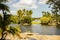 nature landscape of immaculate Fairchild botanic garden with dramatic skies, lake and palm trees