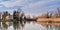 Nature landscape with lake, church and swan.