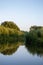 Nature landscape. Reflection of autumn forest in the water