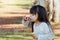 Nature, outdoor and girl blowing bubbles, freedom and playing for fun, development and happiness. Female child, kid and