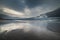 Nature and peace of mind: Strandhill Beach with low clouds on rough sea as the sun sets