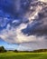 Nature photo field of grass and Rainbow and blue sky with clouds landscape