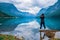 Nature photographer tourist with camera shoots lovatnet lake Beautiful Nature Norway.