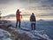 Nature photographers in red and light jacket take photo