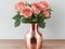 Nature\\\'s Delight: Exquisite Rose Gold Vase on a Rustic Wood Background